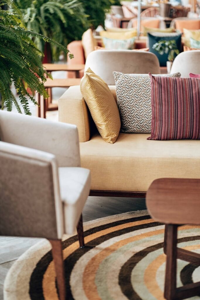 A modern living room with stylish throw pillows and a circular rug.