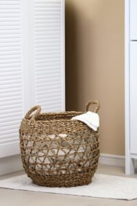 Woven laundry basket placed in a modern, minimalist interior setting, perfect for home organization.