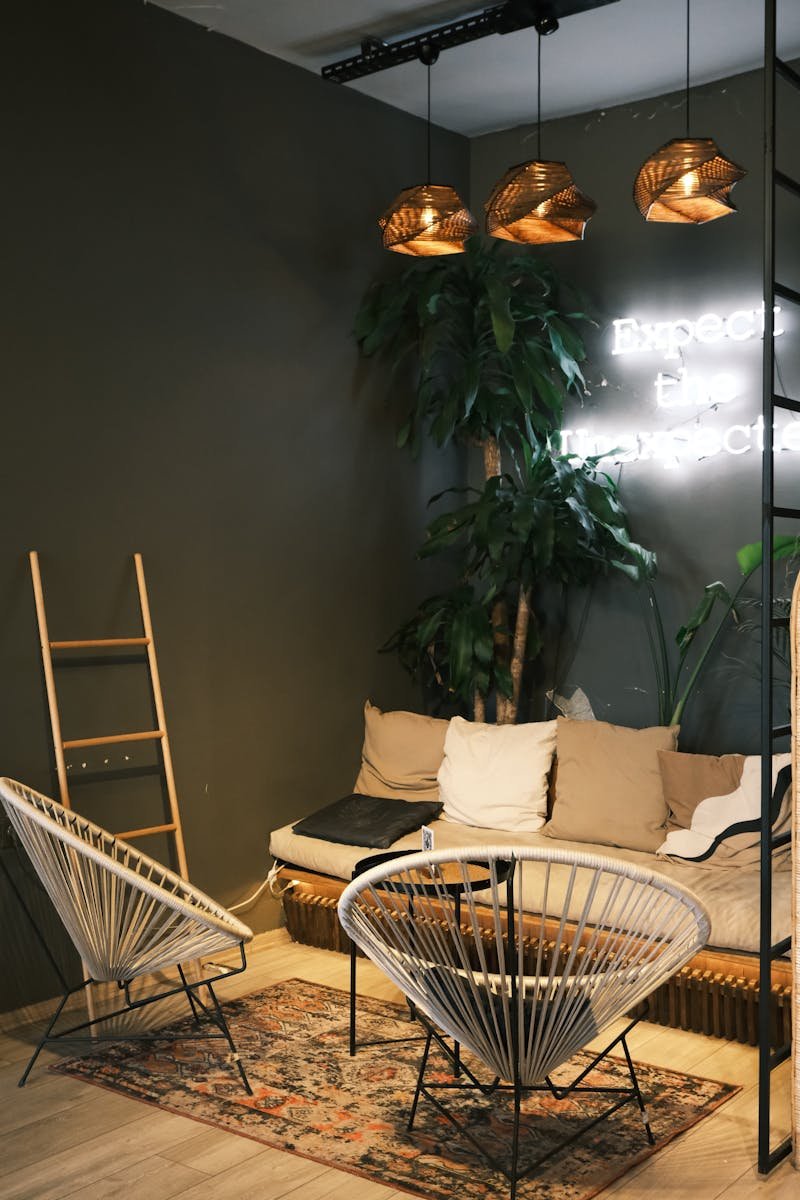 Stylish living room with modern furniture, neon lights, and lush plants for a cozy vibe.