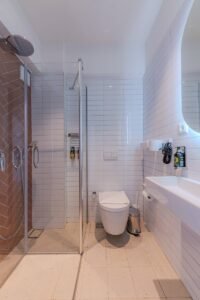 Elegant bathroom design featuring a glass shower and sleek fixtures.